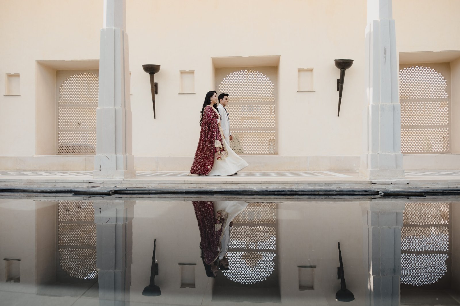 Couple together in a sunlit architectural setting