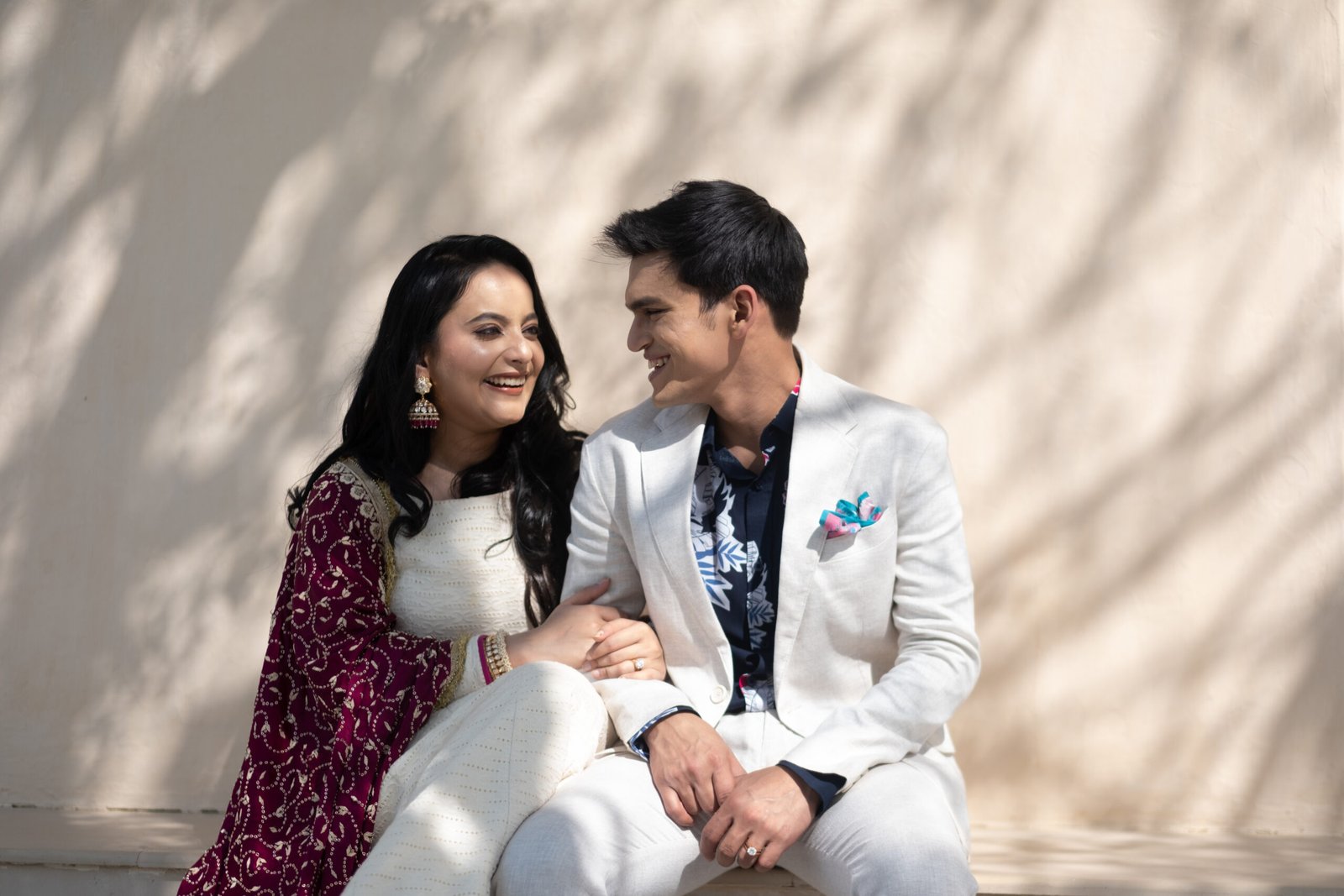 Couple laughing together in warm dappled sunlight