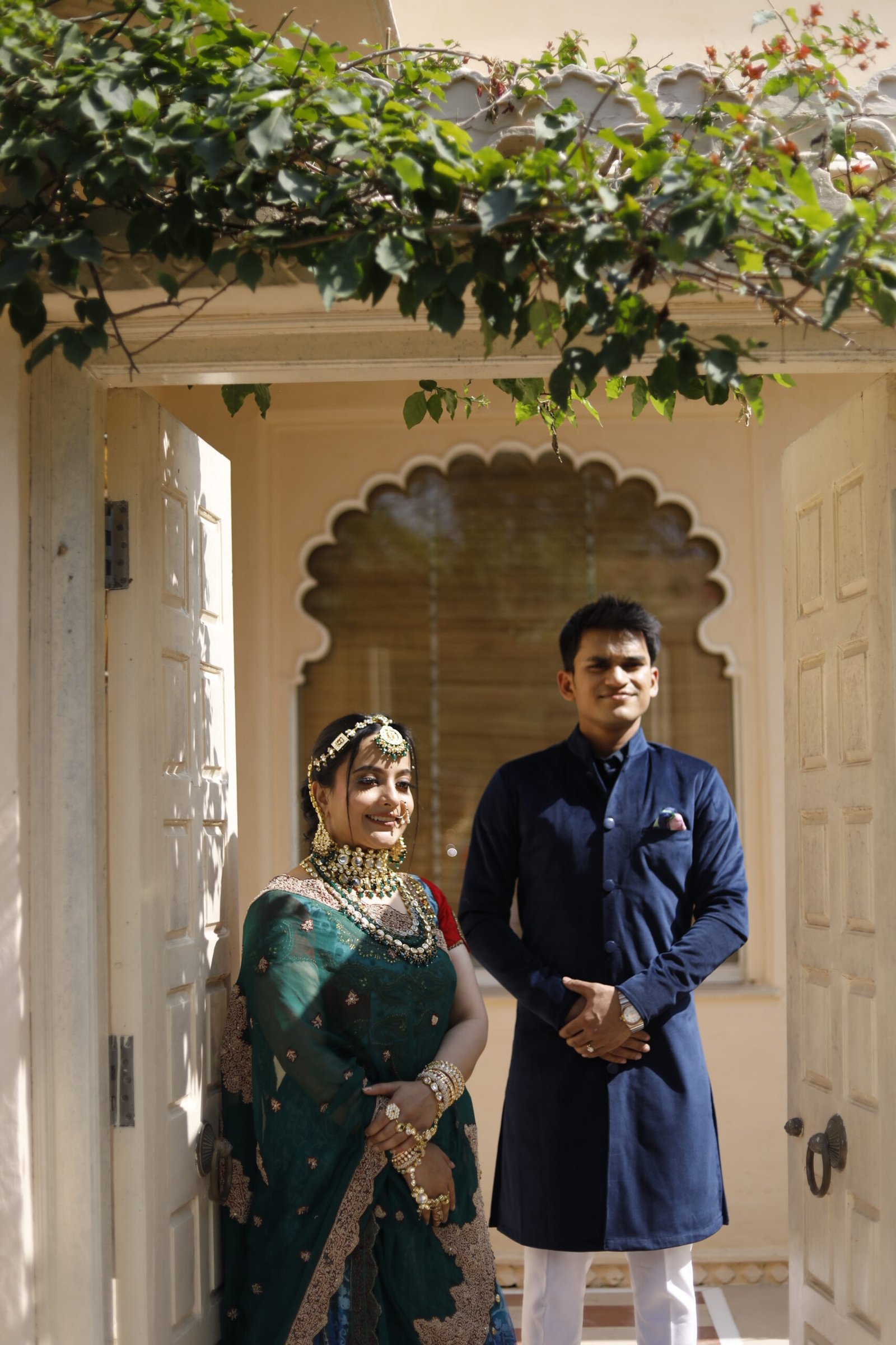 Couple framed by an ornate architectural archway