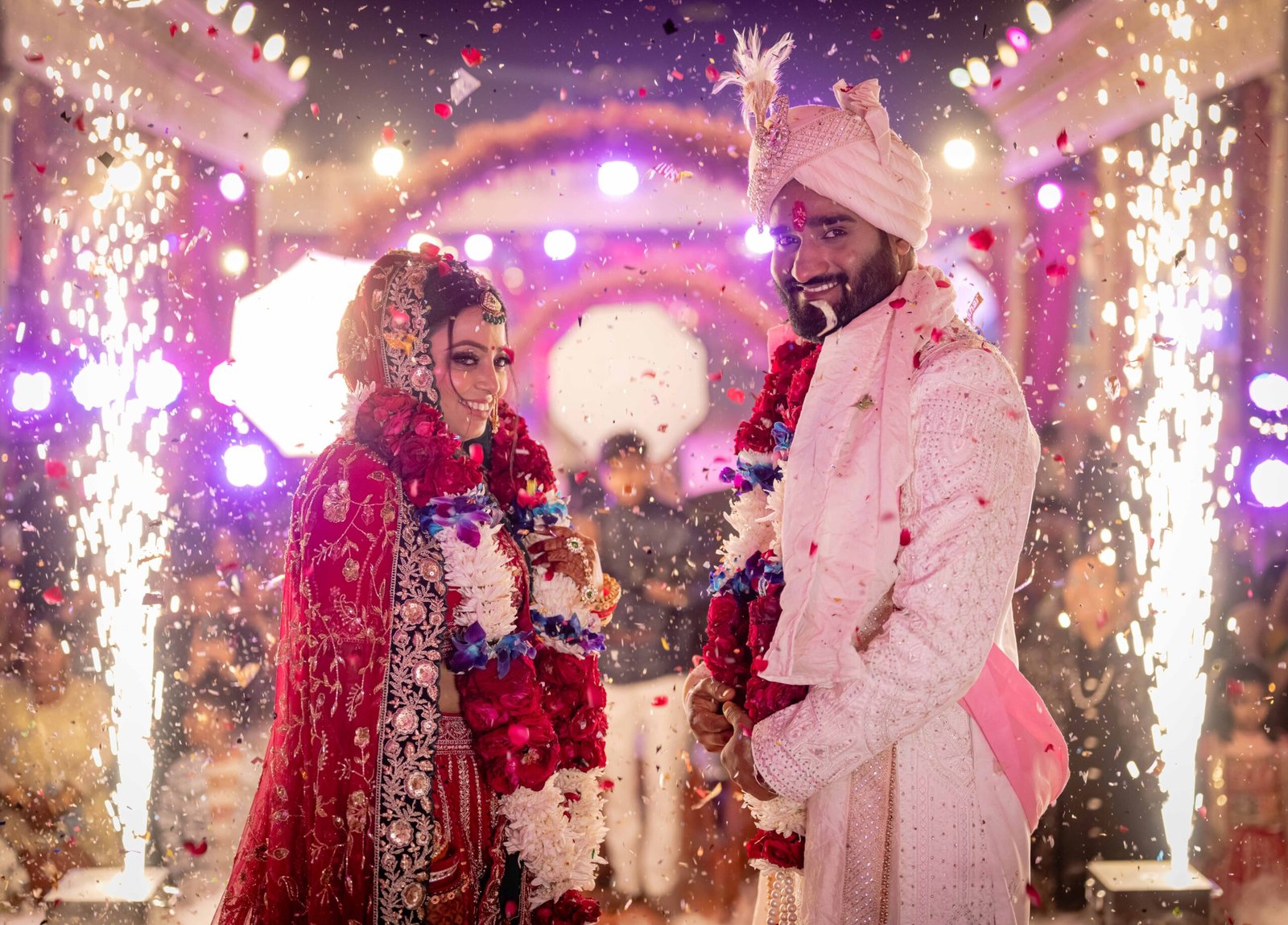 Bride and groom celebrating beneath wedding sparklers